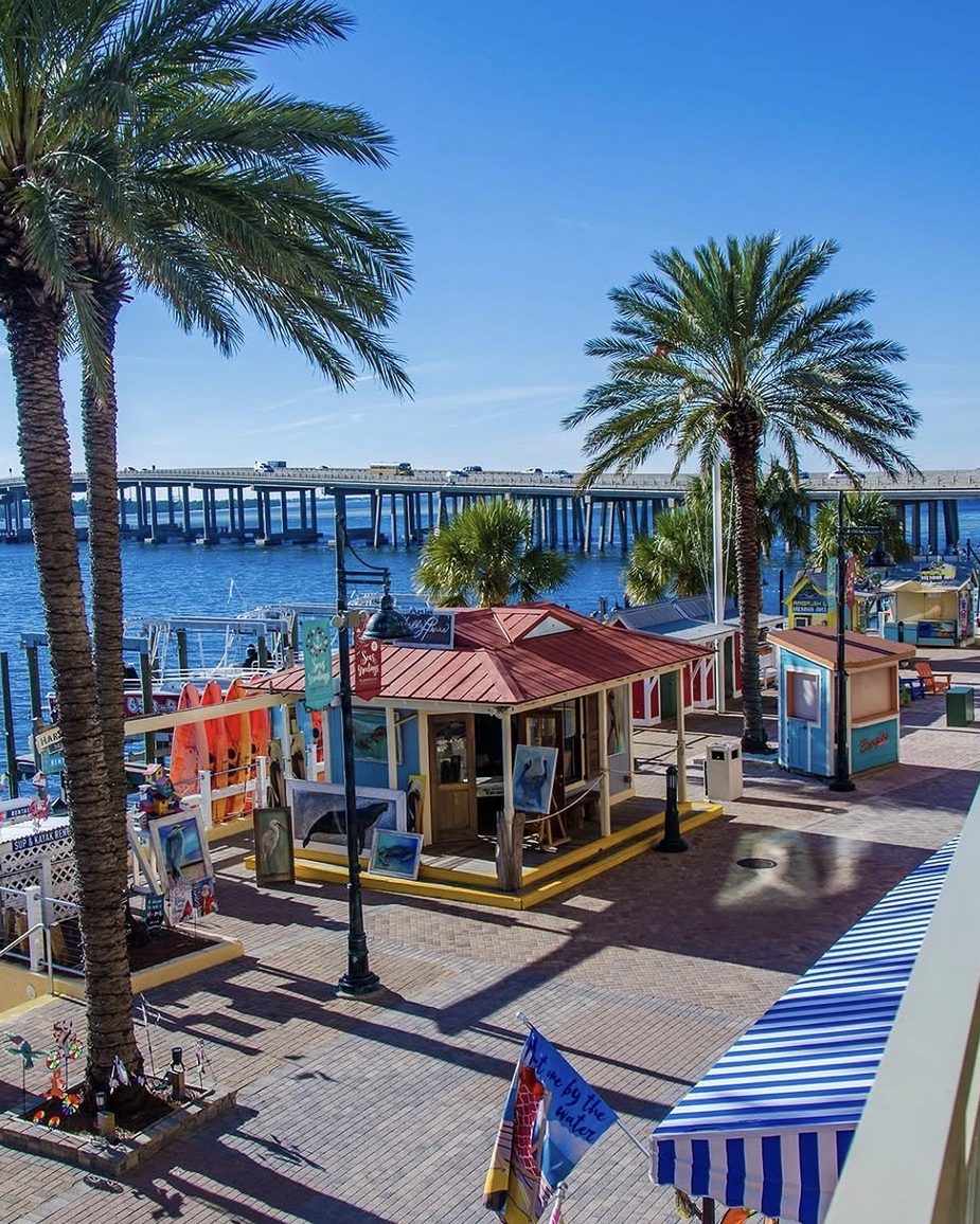 The harbor boardwalk in Destin with the bridge beyond