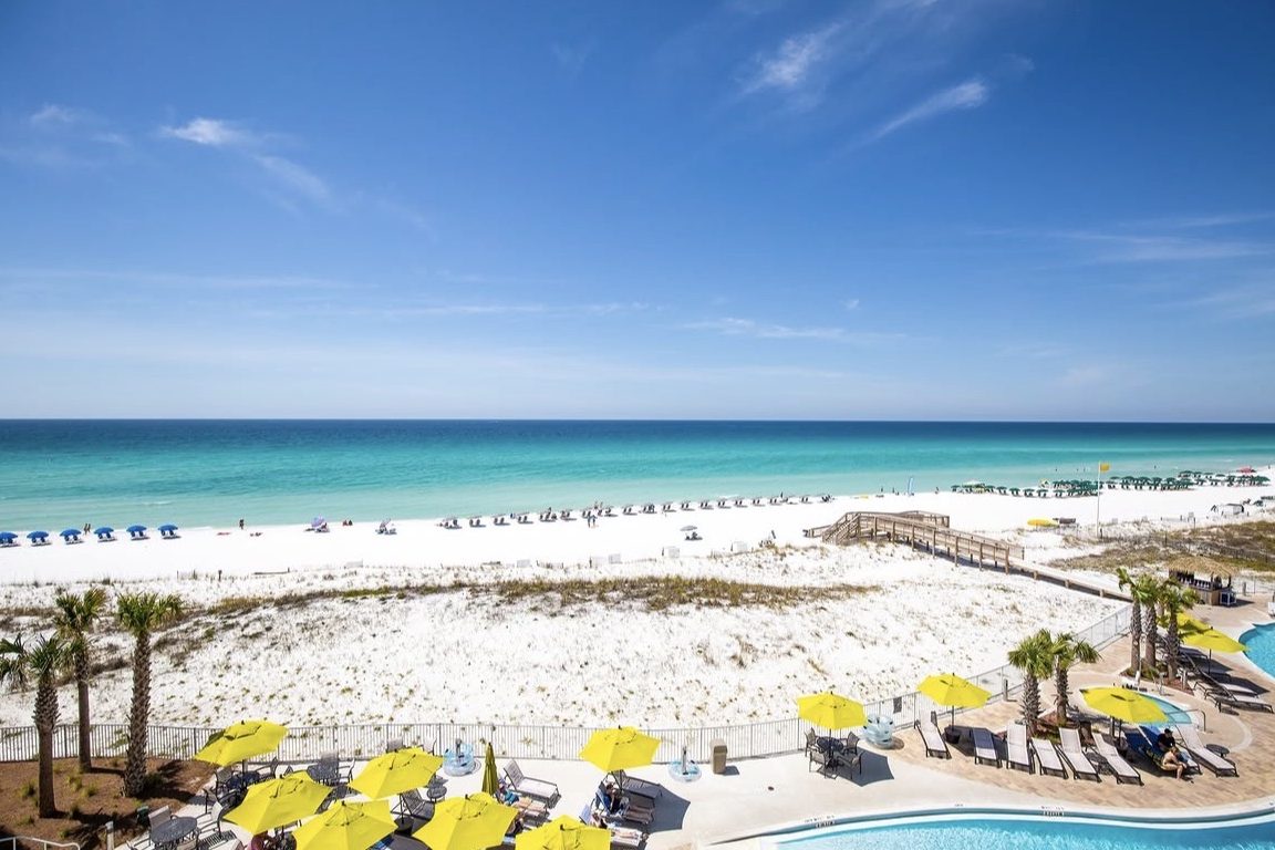 A white-sand beach and resort pool deck in Fort Walton Beach