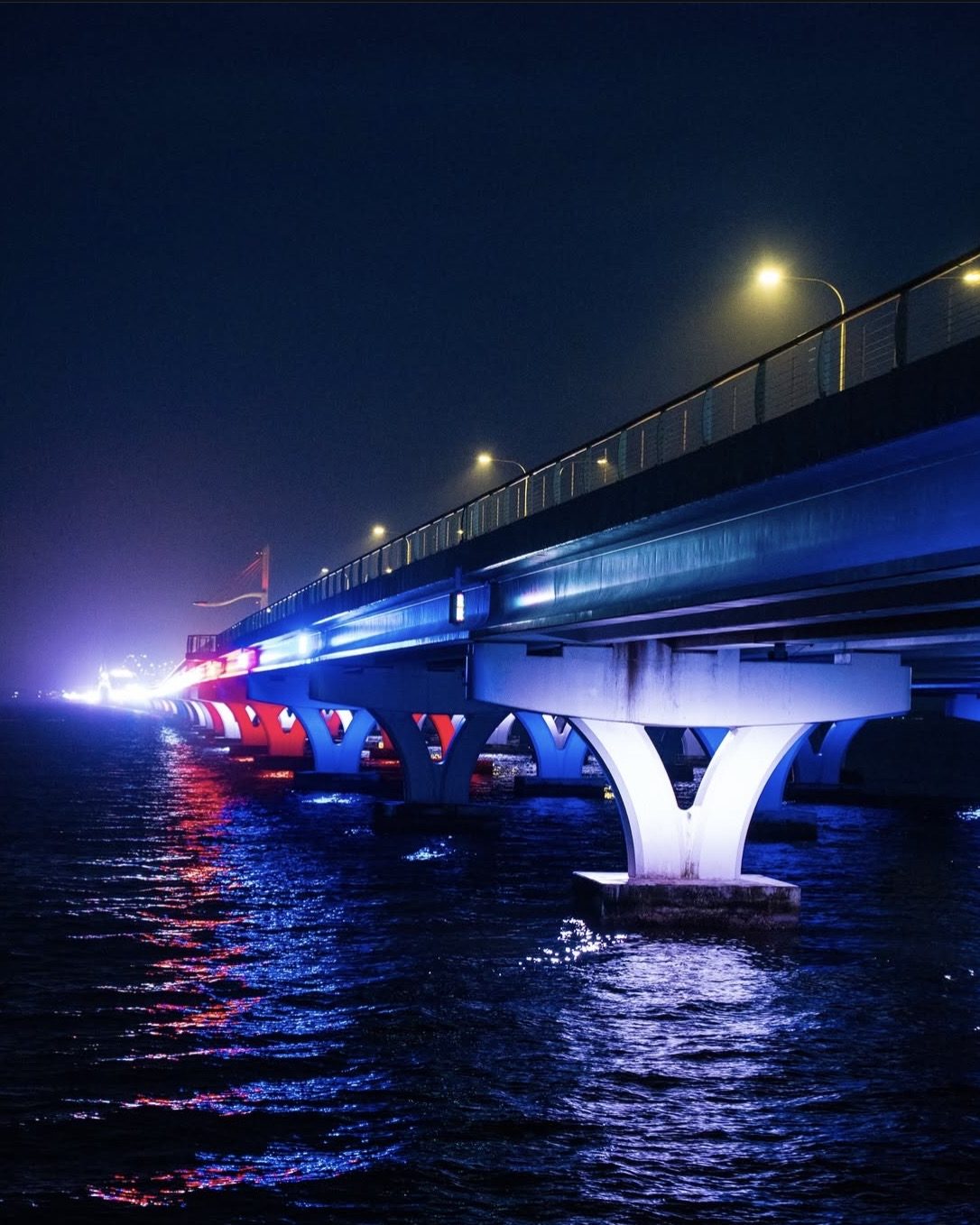 An illuminated bridge near downtown Pensacola at night